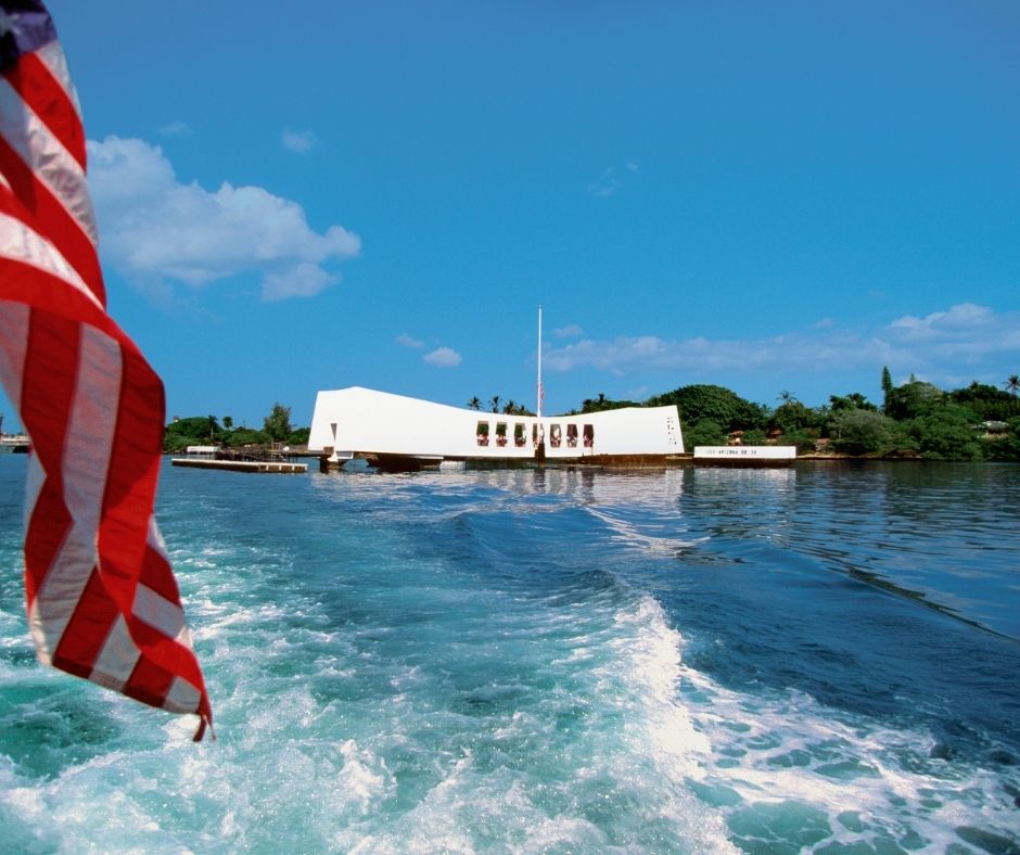 US Flag flying off the back of the USS Arizona in Pearl Harbor, Oahu, Hawaii, USA